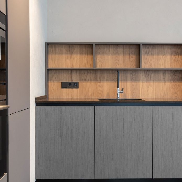 Graphite kitchen run with open oak shelving above