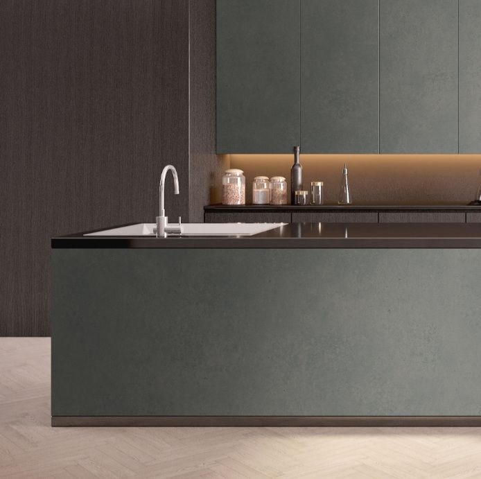 Kitchen island in stone and dark timber with a black counter