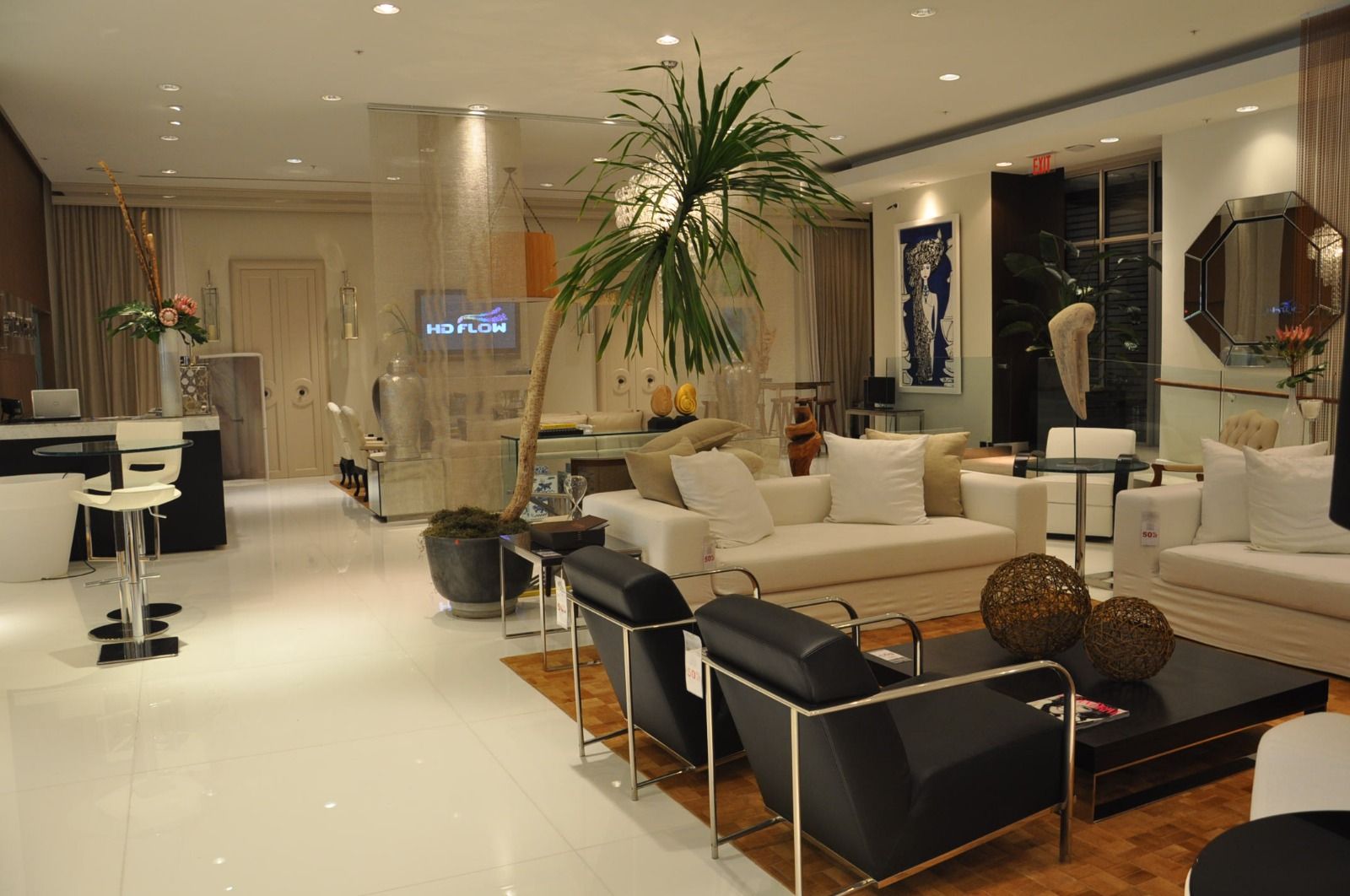 Cream lounge seating with chrome frames under a tall palm