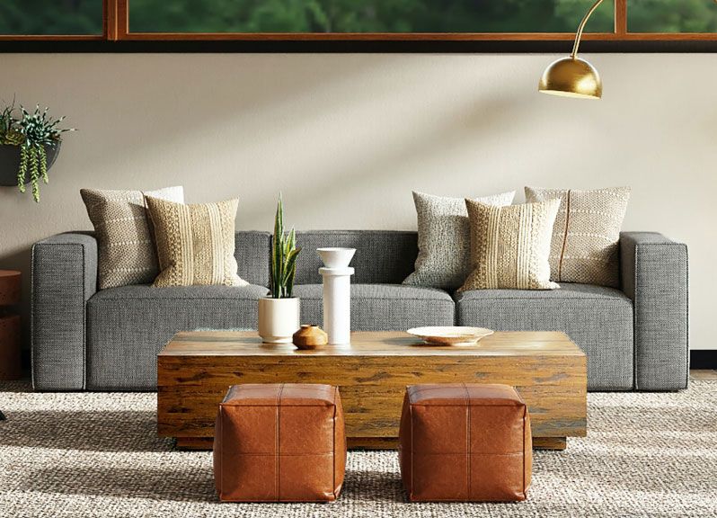 Layered living room with tactile upholstery and a natural rug