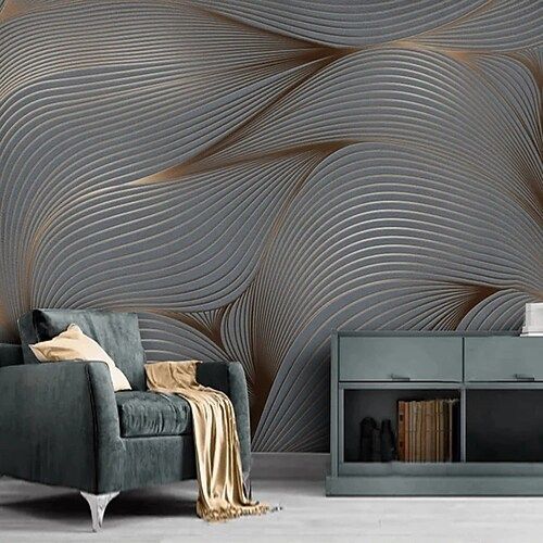Graphite and copper wave mural behind a velvet armchair