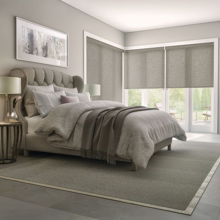 Taupe bedroom with linen roller shades across three windows