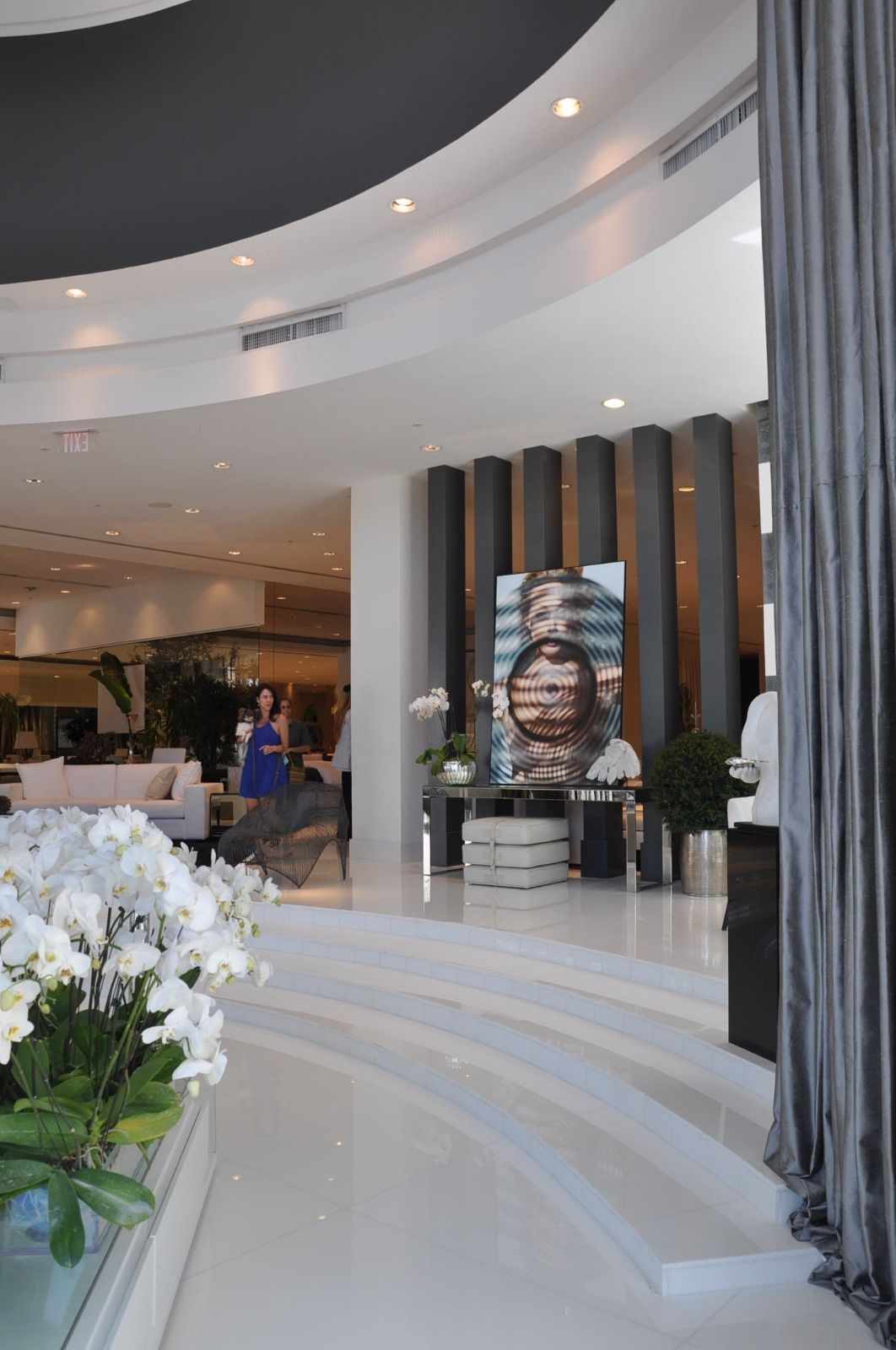 Curved rotunda hung with grey drapery from ceiling to floor