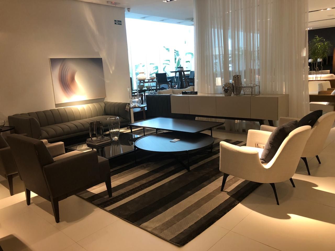 Showroom lounge with dark leather chairs standing on a graphite striped rug